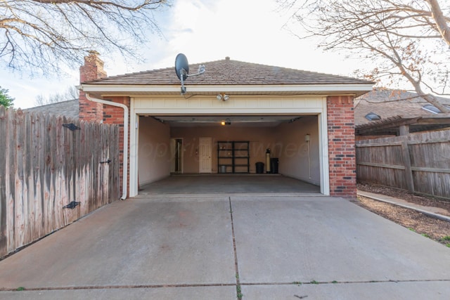 garage with fence and driveway