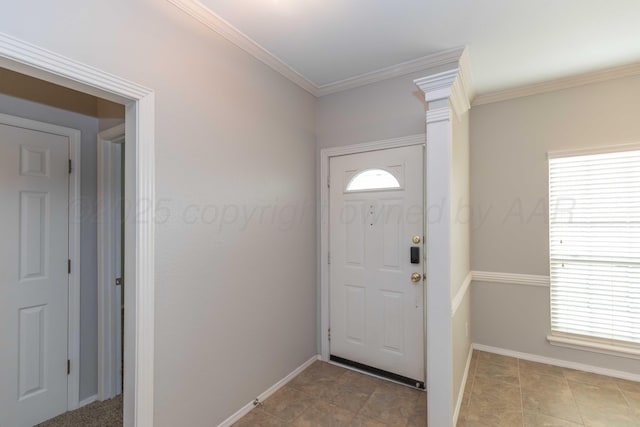 foyer featuring a wealth of natural light, baseboards, and crown molding