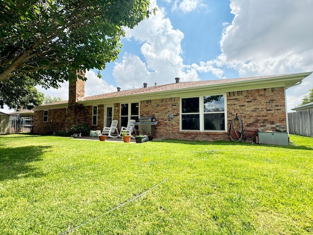 7204 SW 39th Ave, Amarillo, TX 79109 - rear view of house with a chimney, brick siding, and a patio area