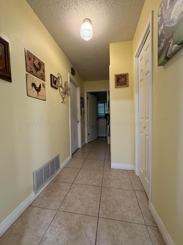 7204 SW 39th Ave, Amarillo, TX 79109 - hallway featuring a textured ceiling and light tile patterned floors