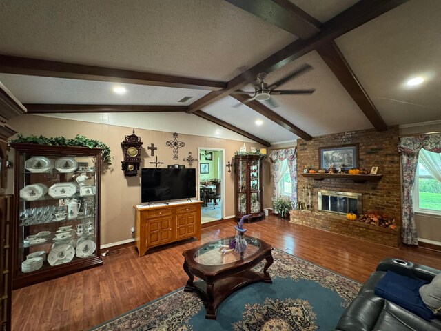 7204 SW 39th Ave, Amarillo, TX 79109 - living room featuring wood finished floors, a ceiling fan, a brick fireplace, and a textured ceiling