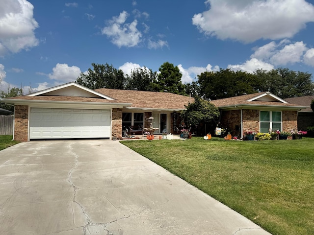 ranch-style house featuring a garage and a front yard