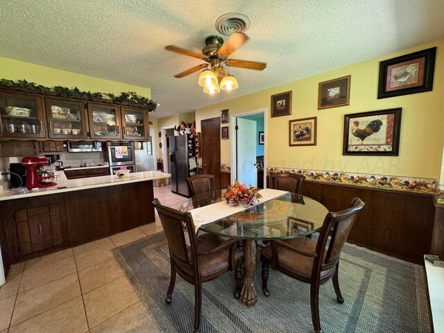 7204 SW 39th Ave, Amarillo, TX 79109 - dining room featuring a textured ceiling, ceiling fan, and light tile patterned floors