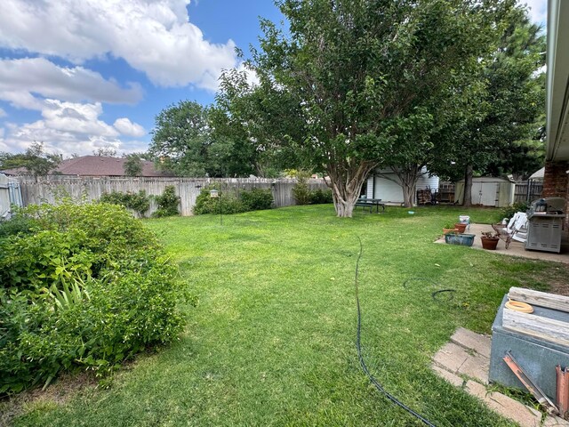 7204 SW 39th Ave, Amarillo, TX 79109 - fenced backyard featuring a shed and a patio