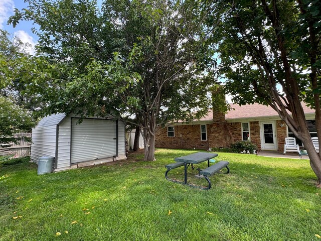 7204 SW 39th Ave, Amarillo, TX 79109 - view of yard featuring a storage unit and a patio area