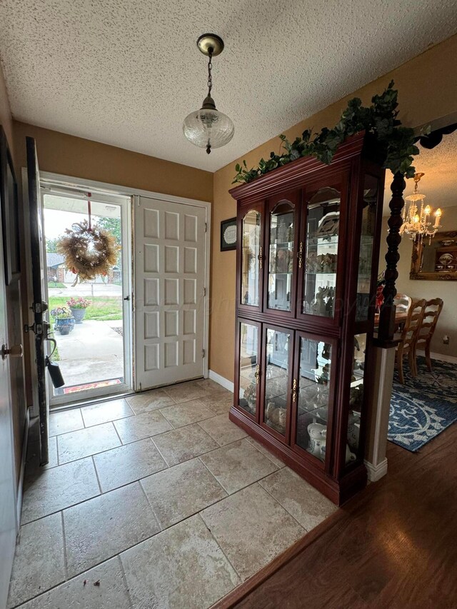 7204 SW 39th Ave, Amarillo, TX 79109 - entrance foyer with a chandelier and a textured ceiling