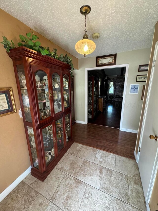 7204 SW 39th Ave, Amarillo, TX 79109 - corridor featuring a textured ceiling and light wood-style floors