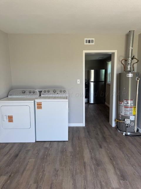 1602 N Hughes St, Amarillo, TX 79107 - laundry area with gas water heater, washing machine and clothes dryer, and dark wood finished floors