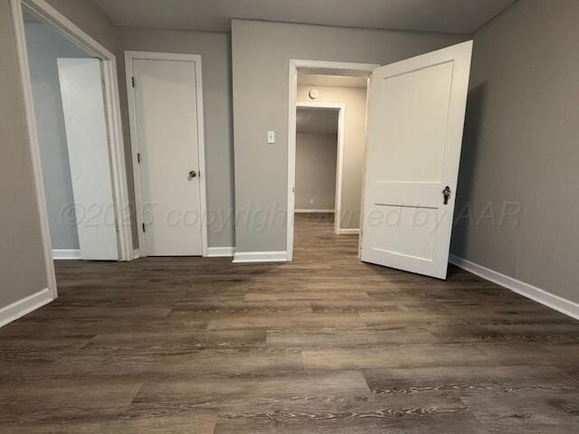 1602 N Hughes St, Amarillo, TX 79107 - unfurnished bedroom featuring dark wood-type flooring and baseboards