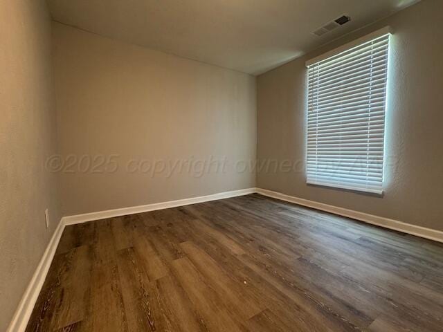 1602 N Hughes St, Amarillo, TX 79107 - unfurnished room with dark wood-type flooring and baseboards