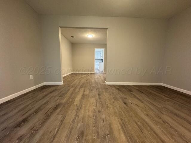 1602 N Hughes St, Amarillo, TX 79107 - empty room featuring dark wood-style floors and baseboards