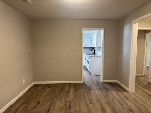 1602 N Hughes St, Amarillo, TX 79107 - unfurnished room featuring dark wood-style flooring and baseboards
