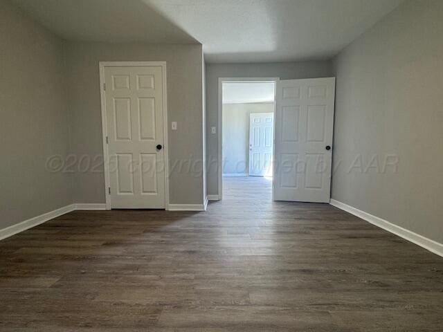 1602 N Hughes St, Amarillo, TX 79107 - spare room featuring baseboards and dark wood-style flooring