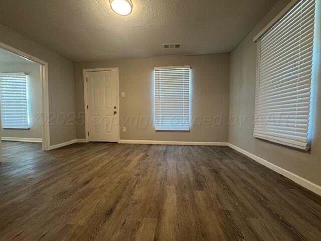 1602 N Hughes St, Amarillo, TX 79107 - empty room featuring dark wood-type flooring and a textured ceiling