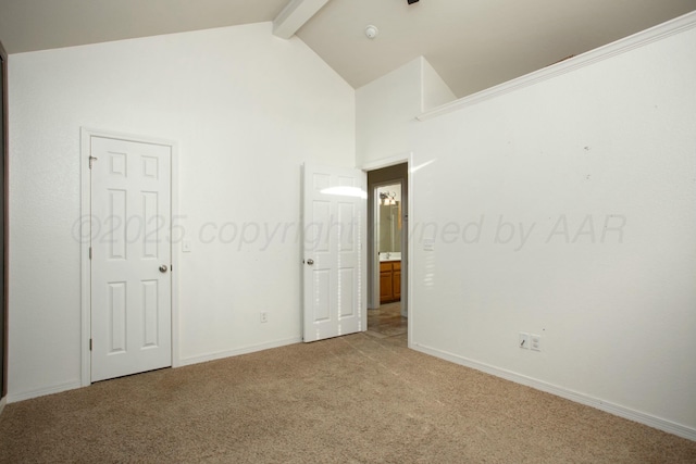 unfurnished bedroom featuring beam ceiling, light colored carpet, high vaulted ceiling, and baseboards