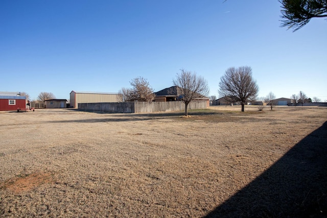 view of yard with an outdoor structure and fence