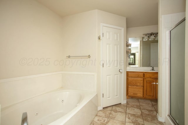 bathroom featuring a stall shower, a jetted tub, and vanity