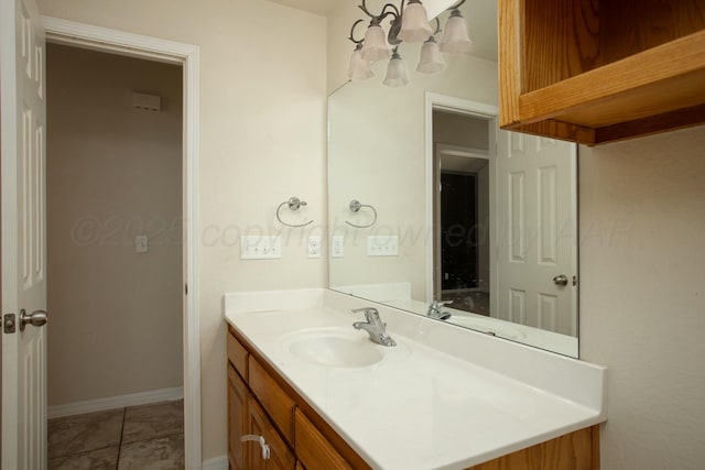 bathroom featuring vanity, baseboards, and tile patterned flooring