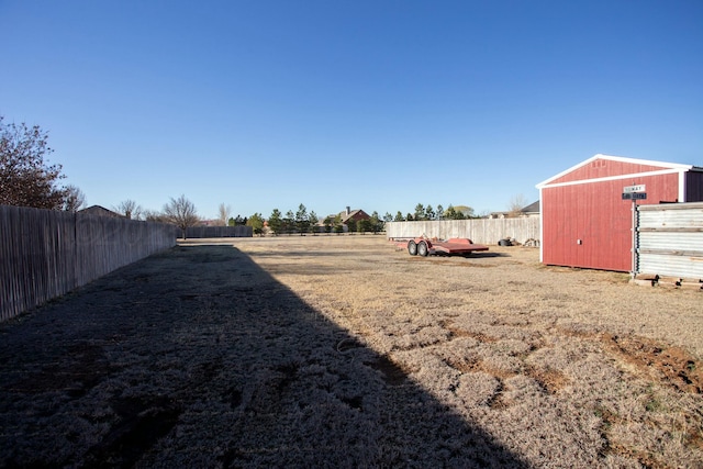 view of yard with an outdoor structure and a fenced backyard