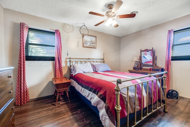 bedroom featuring ceiling fan, a textured ceiling, baseboards, and wood finished floors