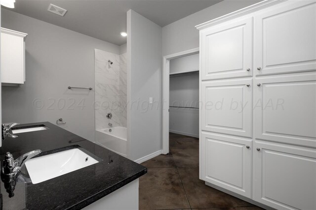 bathroom featuring vanity, tiled shower / bath, and tile patterned floors