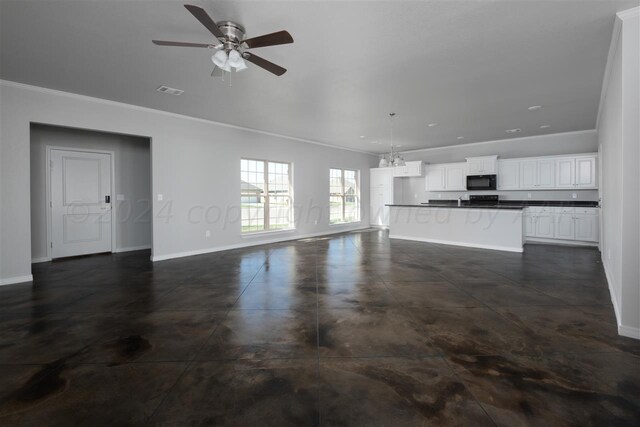 unfurnished living room with ceiling fan and crown molding