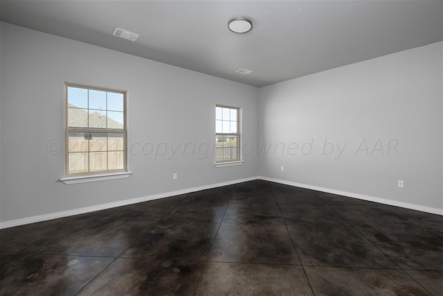 unfurnished room featuring plenty of natural light