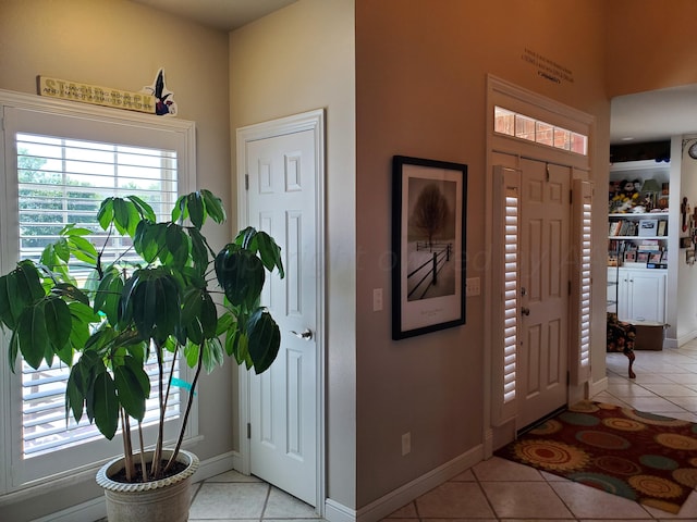 foyer entrance with light tile patterned flooring