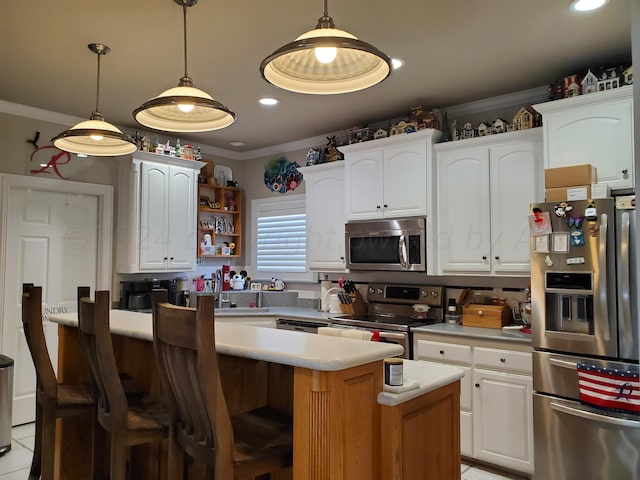 kitchen with white cabinets, appliances with stainless steel finishes, and a kitchen island