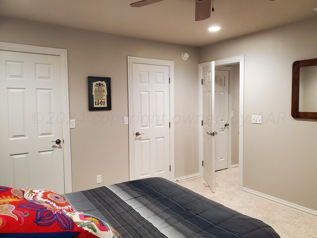 bedroom featuring ceiling fan and light colored carpet