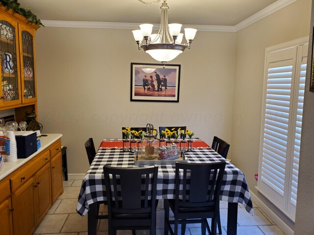 dining room featuring a notable chandelier, light tile patterned floors, and crown molding