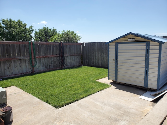 view of yard with a patio area and a storage shed