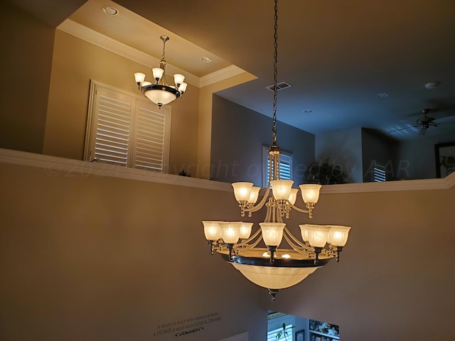 details featuring ceiling fan with notable chandelier and crown molding