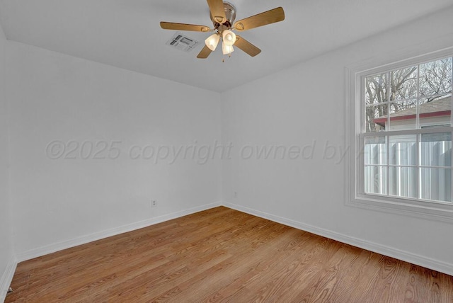 unfurnished room featuring a ceiling fan, light wood-style flooring, visible vents, and baseboards