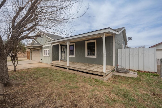 view of front facade featuring a garage, a front lawn, a porch, and concrete driveway