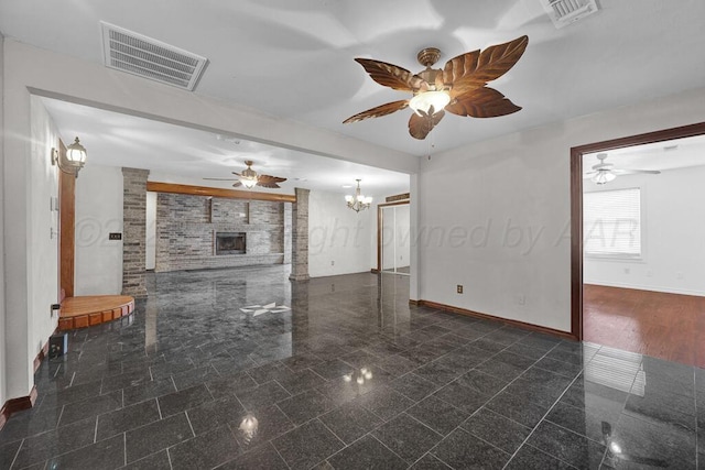 unfurnished living room featuring granite finish floor, baseboards, and visible vents