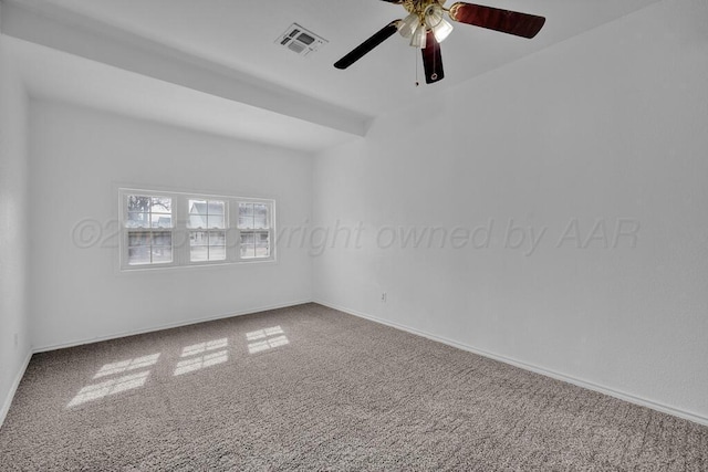 carpeted empty room with baseboards, visible vents, and a ceiling fan