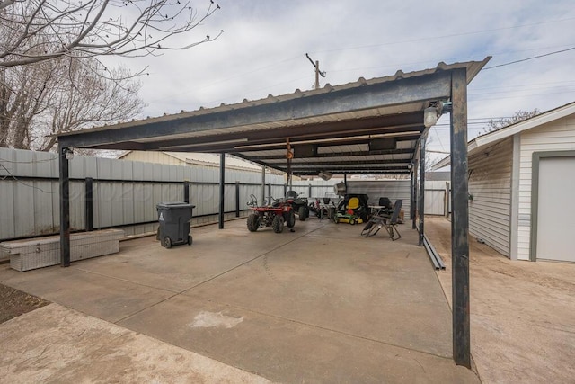 view of vehicle parking with fence