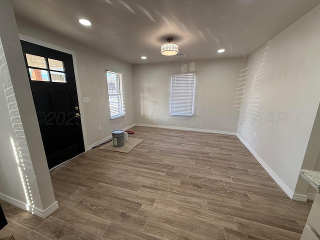 entrance foyer with recessed lighting, baseboards, and wood finished floors