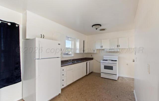 kitchen featuring white cabinetry, white appliances, and sink