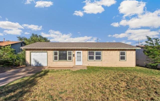 ranch-style home featuring a garage and a front lawn