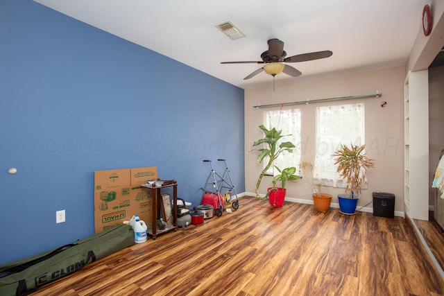 recreation room featuring a ceiling fan, baseboards, visible vents, and wood finished floors