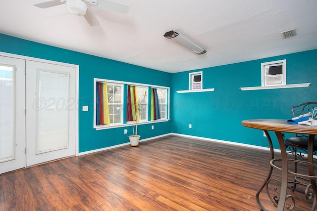 unfurnished dining area featuring visible vents, baseboards, ceiling fan, and wood finished floors