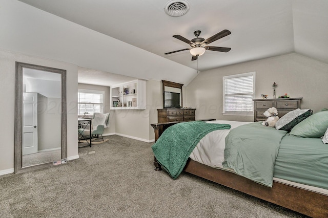 carpeted bedroom with visible vents, baseboards, ceiling fan, and vaulted ceiling