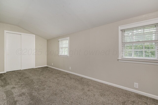 2421 Duncan St, Pampa, TX 79065 - unfurnished bedroom featuring carpet floors, vaulted ceiling, multiple windows, baseboards, and a closet