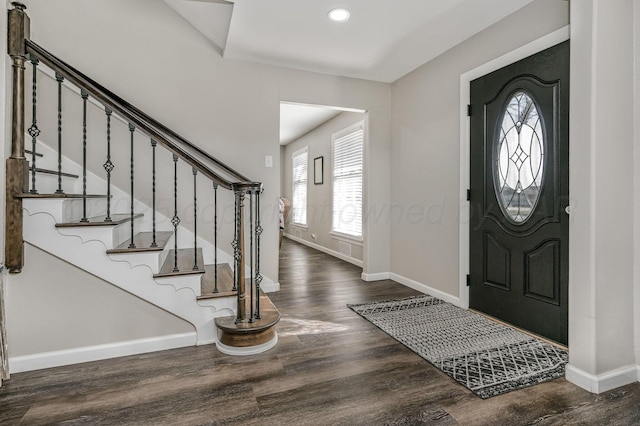 foyer entrance featuring baseboards, plenty of natural light, and wood finished floors