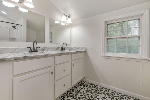 2421 Duncan St, Pampa, TX 79065 - bathroom with double vanity, baseboards, and lofted ceiling