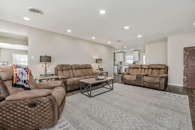 living room with a healthy amount of sunlight, recessed lighting, visible vents, and wood finished floors