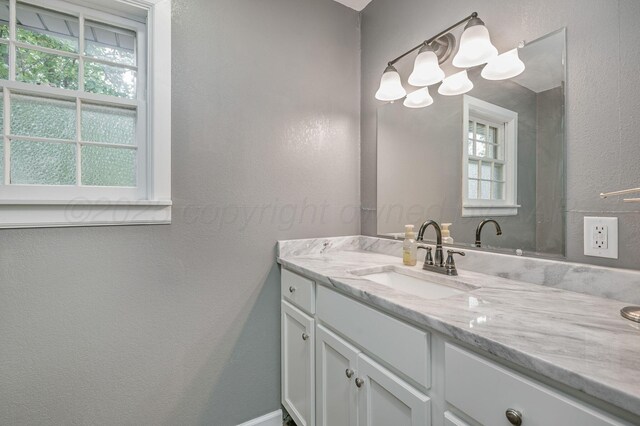 2421 Duncan St, Pampa, TX 79065 - bathroom with vanity, plenty of natural light, and a textured wall