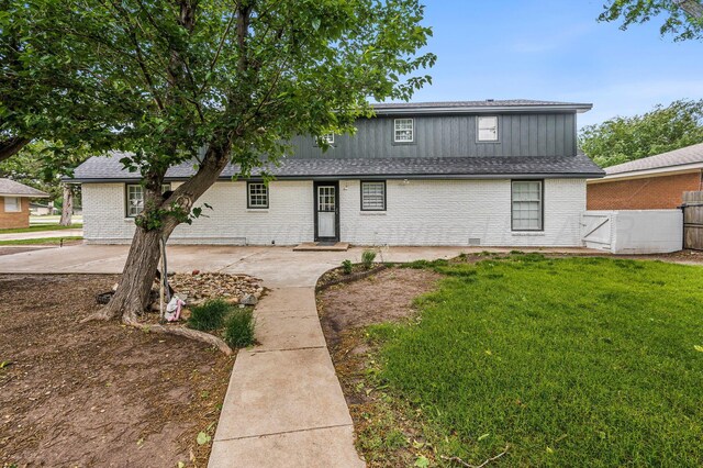 2421 Duncan St, Pampa, TX 79065 - view of front of house with brick siding, a patio area, board and batten siding, and entry steps